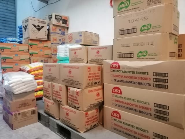 Rice packs and biscuit boxes inside an inventory room