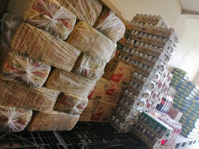 Soft drink and cooking oil boxes inside an inventory room