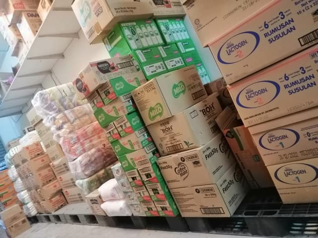 Chocolate powder and mineral water boxes inside an inventory room